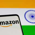Amazon to Invest $35B in India by 2030 for Jobs & AI Growth FILE PHOTO: Smartphone with Amazon logo is seen in front of displayed Indian flag in this illustration taken