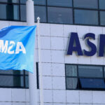 ASML Raises Its 2026 Outlook Again As AI Chip Demand Keeps Surging FILE PHOTO: An ASML flag and signage at the company's offices in Veldhoven